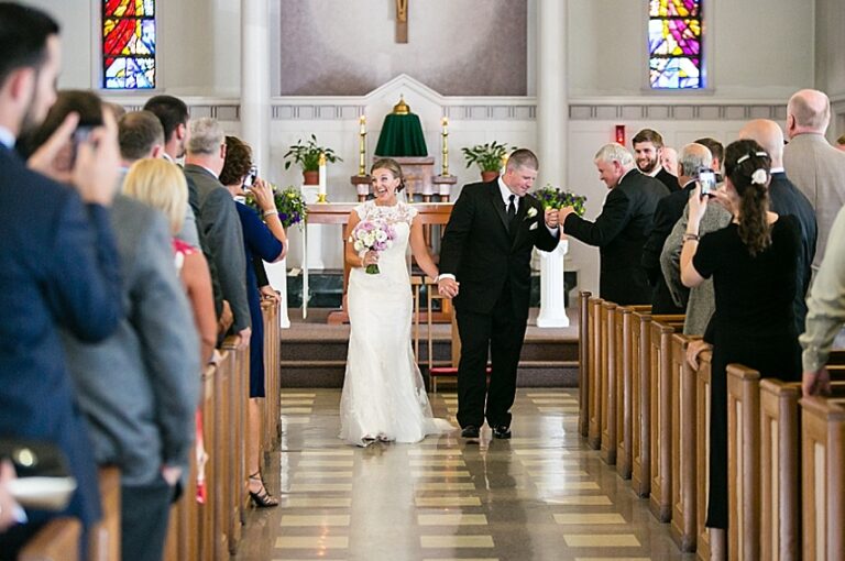 Bride and groom walking down the aisle after their wedding ceremony.