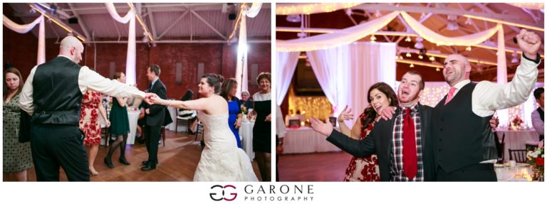 Bride and groom dancing joyfully at their wedding reception.