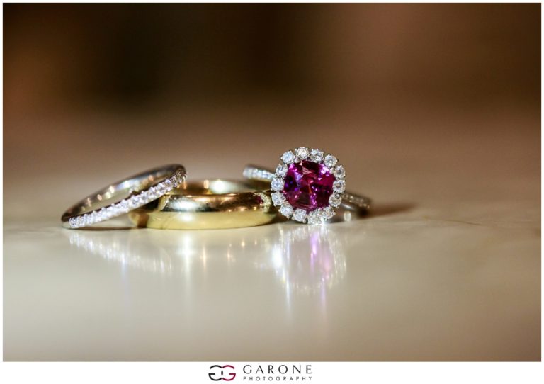 Close-up of three elegant rings with reflections on a smooth surface.