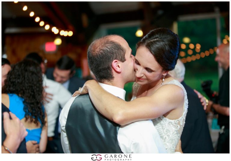 Bride and groom sharing a joyful dance at their wedding reception.
