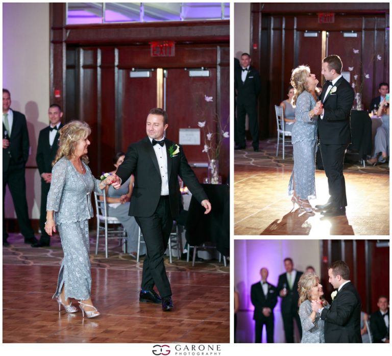 Couple dancing elegantly at a formal event with guests watching.