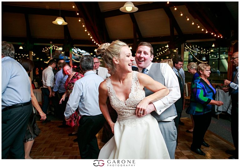 Bride and groom joyfully dancing at their wedding reception.
