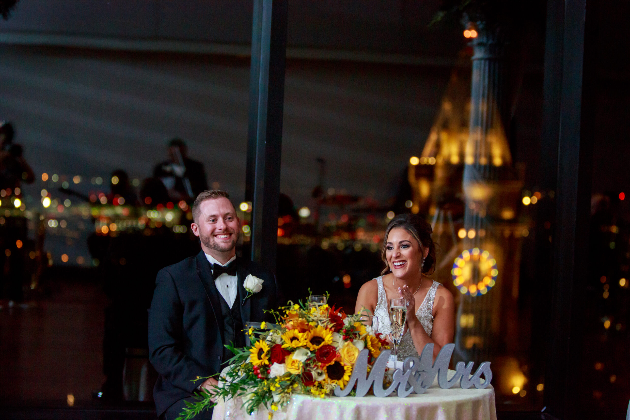 Bride and groom smiling during wedding reception at The State Room in Boston.